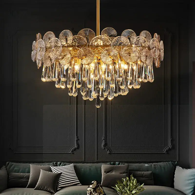 Nordic golden crystal lotus chandelier featuring intricate fan-shaped glass discs and dangling crystal teardrops for dining room luxury
