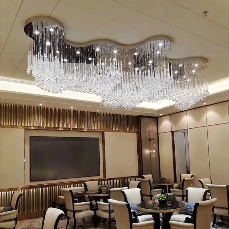A decorbites crystal luxury chandelier with wavy cloud-like design and clear glass prisms for dining room and hotel lobby