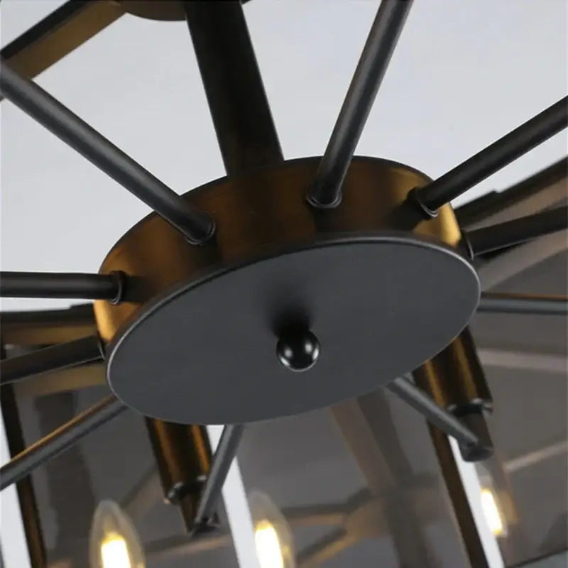 Decorbites crystal pendant industrial-style ceiling light with black and brass-toned metal arms radiating from base