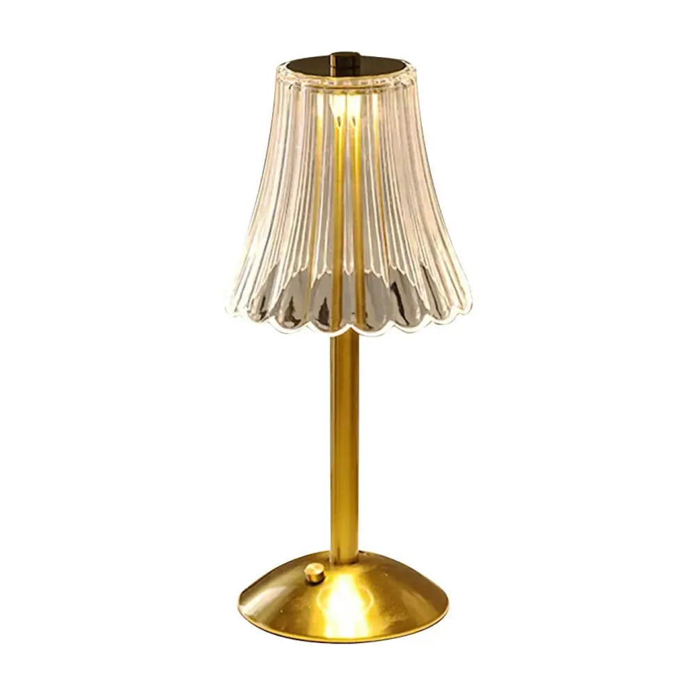 A slender brass decorbites™ crystal retro table lamp with a fluted glass shade for a luxurious bedroom atmosphere