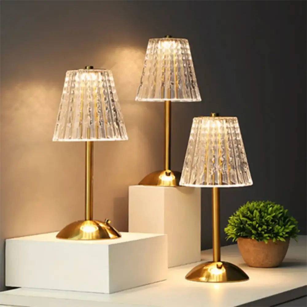 Three elegant gold-toned decorbites crystal retro table lamps with faceted crystal shades for luxurious bedside lighting