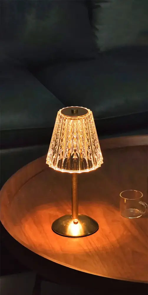 A warm-glowing decorbites™ crystal retro table lamp with brass base and textured glass shade for bedroom ambiance