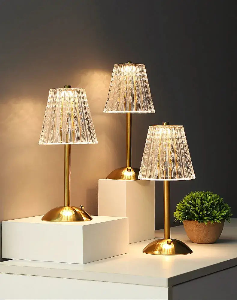 Three elegant gold-toned DecorBites crystal retro table lamps with faceted shades for a luxurious bedroom atmosphere