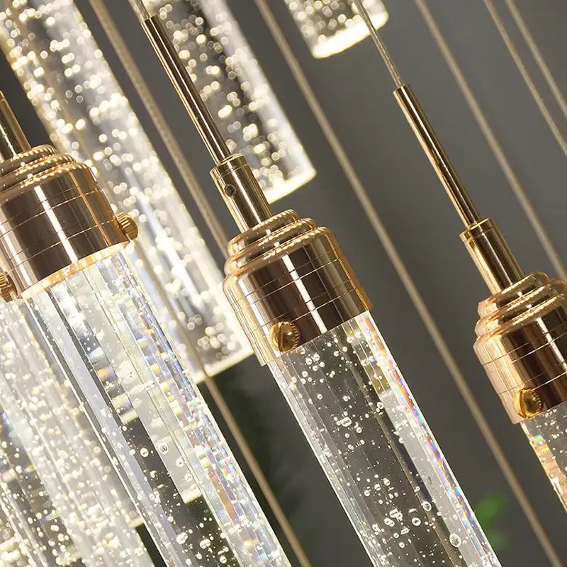 Clear glass decorbites crystal staircase chandelier with gold-toned metal fixtures and internal led lights for modern interiors