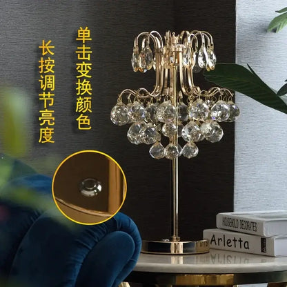 Gold-toned decorbites crystal table lamp with chandelier style and dangling faceted clear crystals for bedroom lighting
