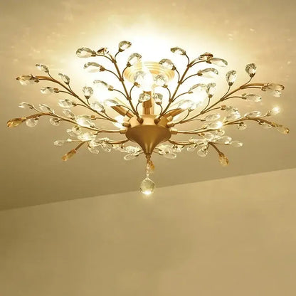 Gold-toned decorbites crystal tree chandelier with intricate branch arms and clear crystal droplets for bedroom lighting