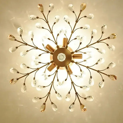 Gold-toned decorbites crystal tree chandelier with delicate crystal teardrop pendants and central circular fixture