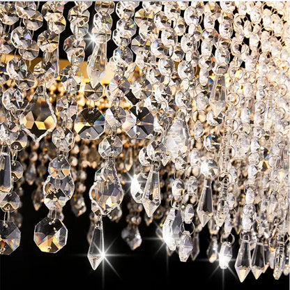 A dazzling gold decorbites crystal waterfall chandelier with cascading faceted beads for dining room lighting