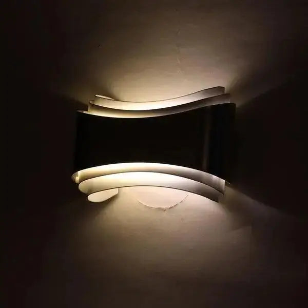 DecorBites™ curved modern wall sconce in black and white with sleek layered design and integrated LED lighting