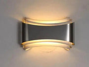 Decorbites™ curved modern wall sconce in brushed stainless steel with layered design and warm led lighting