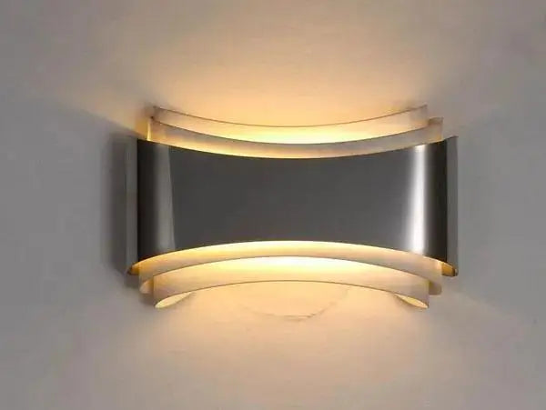 Decorbites™ curved modern wall sconce in brushed stainless steel with layered design and warm led lighting
