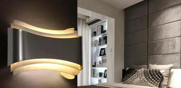 DecorBites curved modern wall sconce with sleek metallic finish and warm glowing LED light for modern wall decor