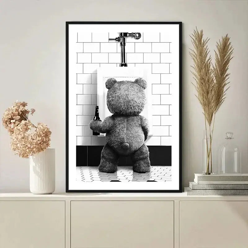 Black-framed DecorBites™ canvas print featuring a gray cute bear in a bear bathroom holding a dark bottle