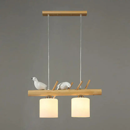 DecorBites™ minimalist wooden pendant light with cylindrical milk glass shades and white resin bird deco for country style restaurants