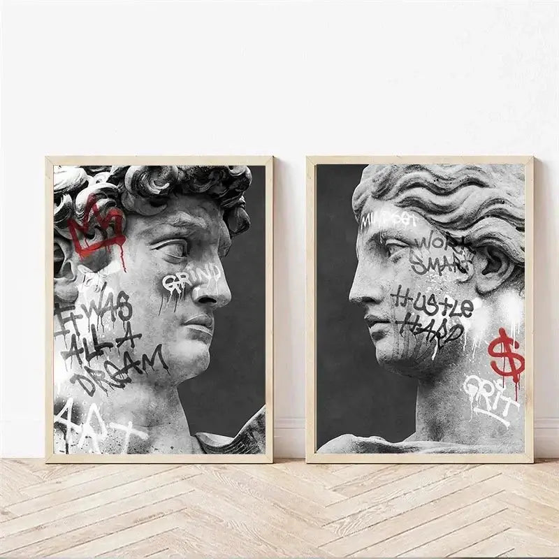 Two framed black-and-white graffiti art canvas prints of classical statues with motivational phrases for room decor