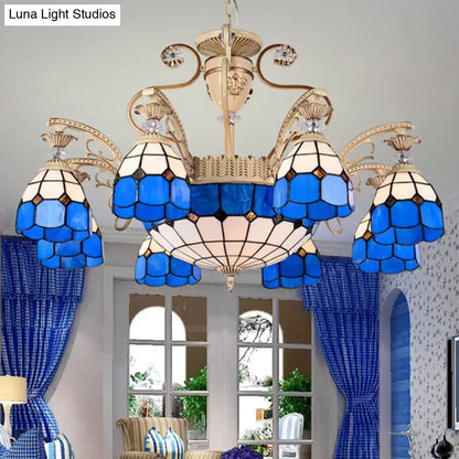 DecorBites dazzling Baroque light fixture featuring a blue and white stained glass chandelier with gold metal arms