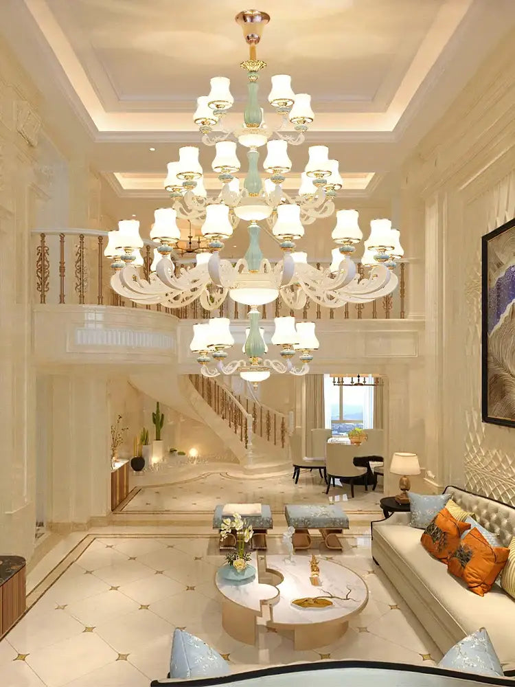A grand decorbites deluxe duplex living room chandelier with multi-tiered light blue and gold glass design