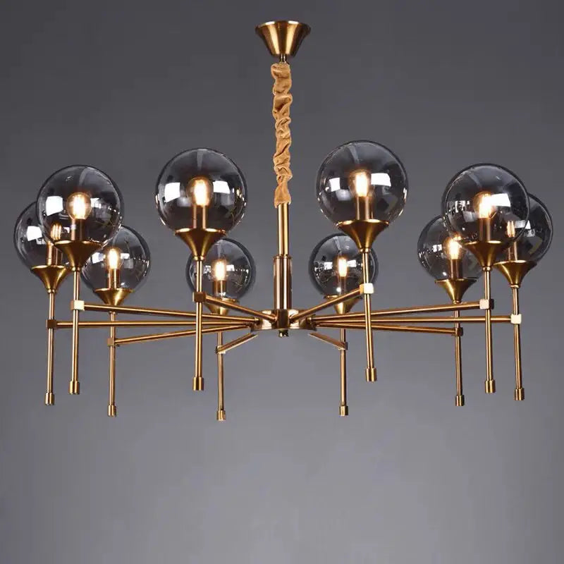 Decorbites™ designer metal chandelier with brass finish, spherical glass globes, and twisted fabric accent for modern living