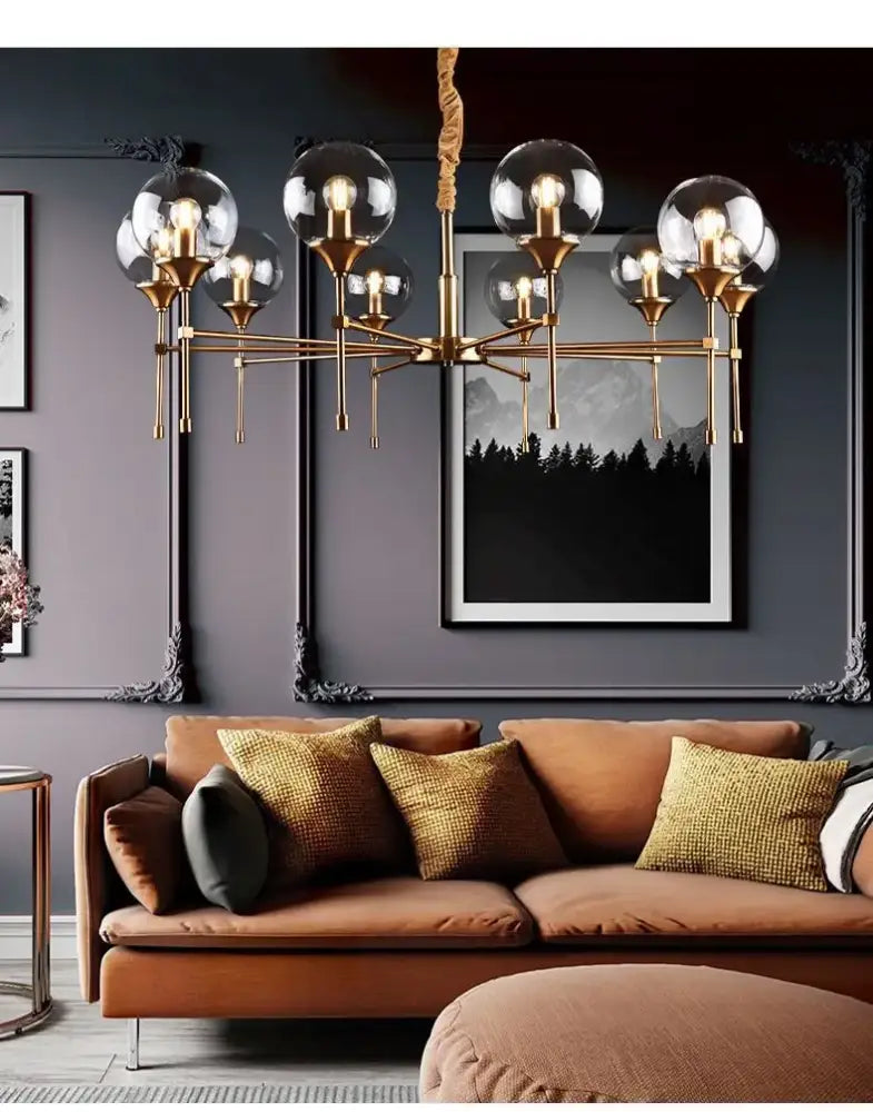 Brass designer metal chandelier with clear glass globe shades for modern living by decorbites