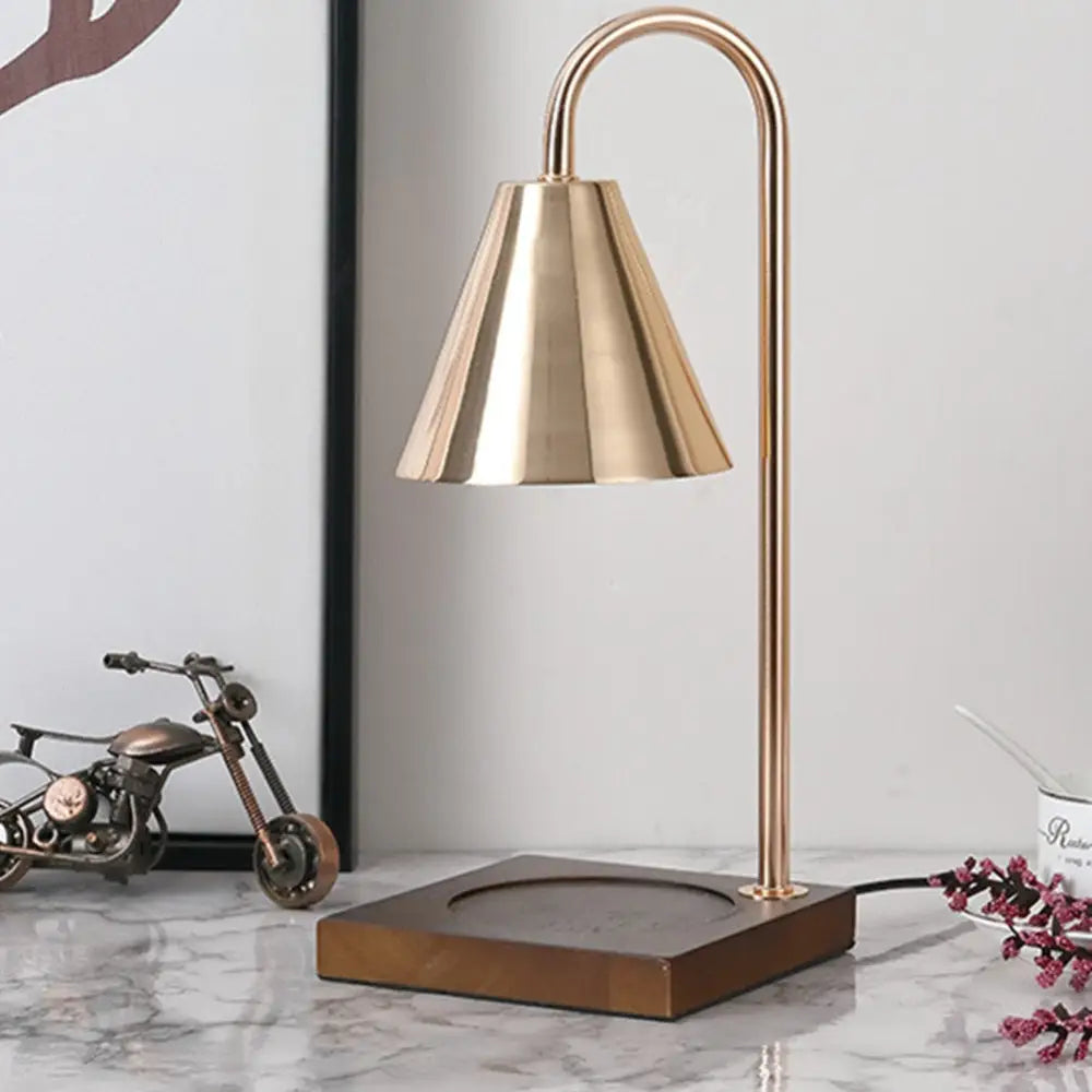 Brass bell-shaped dimmable candle warmer lamp with curved stem and square wooden base by DecorBites™