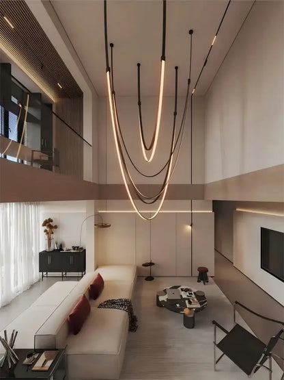 Modern minimalist DecorBites™ DIY flexible leather belt LED chandelier with sleek curved light strips and warm glow