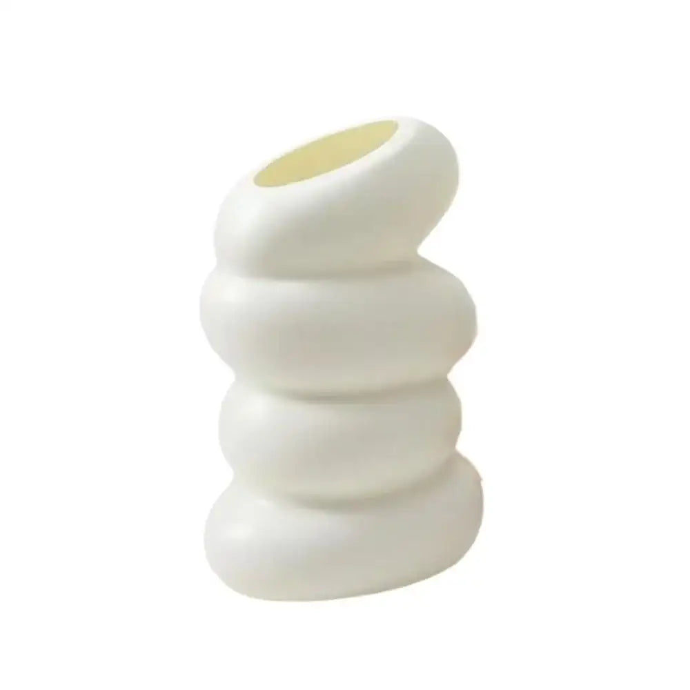 White ceramic donut shape flower vase with stacked rounded segments and a smooth matte finish by DecorBites