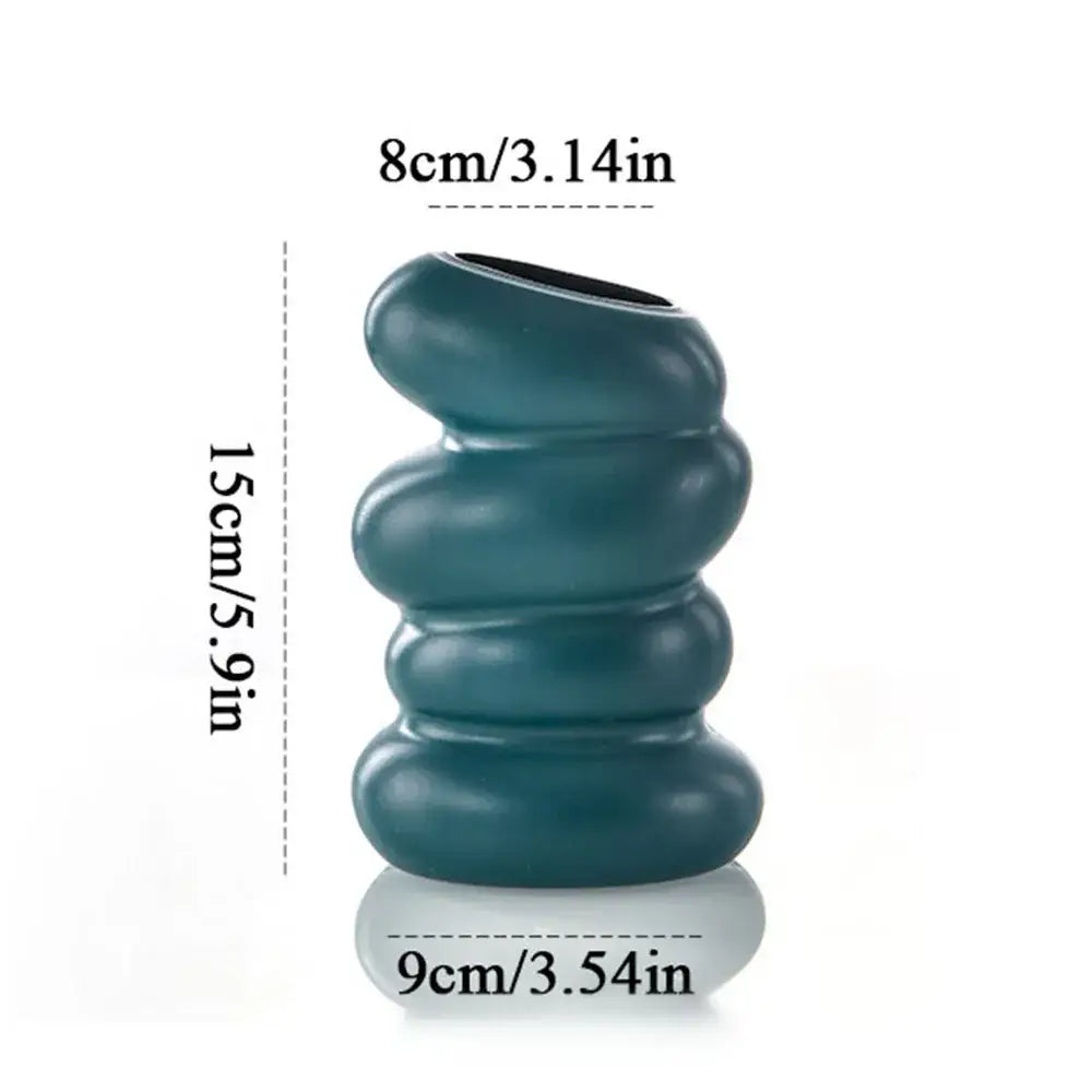 Teal ceramic flower vase with donut shape stacked rounded segments and glossy finish for minimalist decor