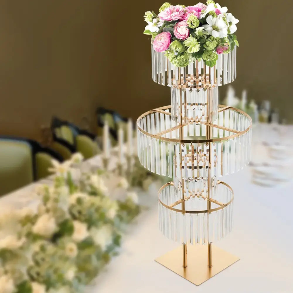 DecorBites™ elegant three-tiered gold wedding flower stand with crystal rods holding pink and white floral bouquet