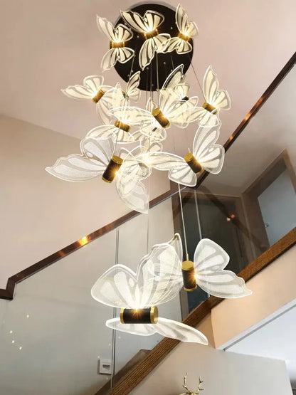 A decorbites elegant butterfly chandelier with white translucent butterfly lights and gold accents for bedroom lighting