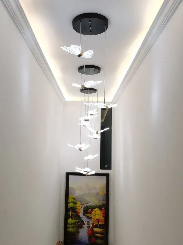 Decorbites elegant butterfly chandelier features cascading translucent white butterfly lights with black circular fixtures