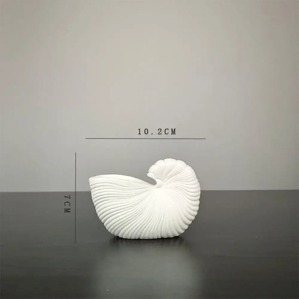 DecorBites™ elegant ceramic vase featuring a white shell conch design with intricate ridges and glossy finish