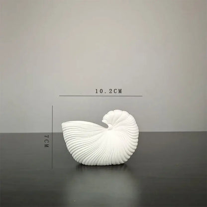DecorBites™ elegant ceramic vase featuring a white shell conch design with intricate ridges and glossy finish