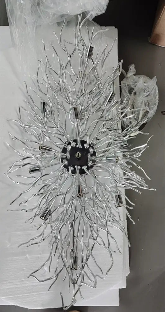 Silver metallic DecorBites™ elegant chrome crystal chandelier with intricate branching arms and central black hub for living room