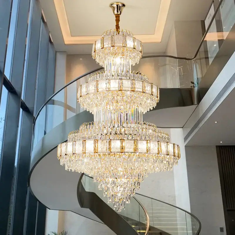 A decorbites elegant crystal multi-tiered chandelier with gold-toned metal and clear glass prisms for dining rooms