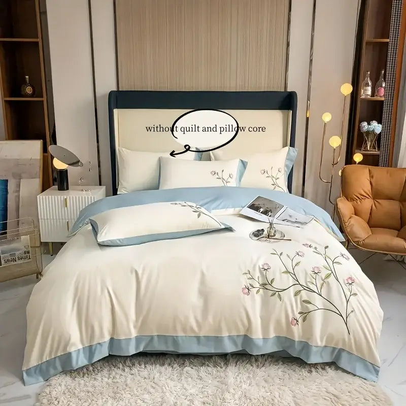 Cream-colored DecorBites elegant embroidery duvet cover set with pink and green floral embroidery and blue piping edges
