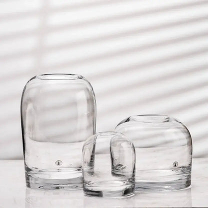 Clear glass flower vases with rounded bulbous shapes and thick bases by DecorBites elegant European INS