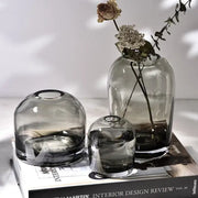 A set of three translucent gray glass flower vases with rounded shapes and subtle gradient from decorbites™ elegant european ins