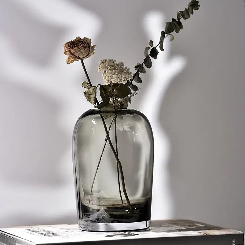 DecorBites™ elegant European INS glass flower vase in sleek dark gray glass with rounded body and clear base holding dried flowers