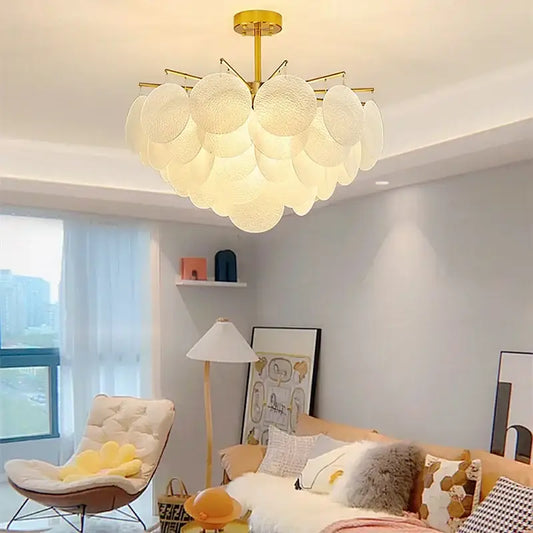 Gold-toned decorbites elegant glass chandelier with textured white circular shades ideal for bedroom lighting