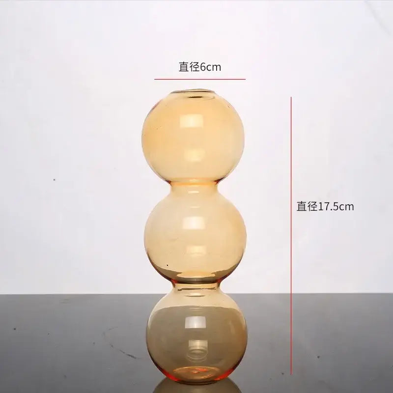 Amber-colored DecorBites™ elegant glass vase with three stacked spherical sections for stylish home decor accent