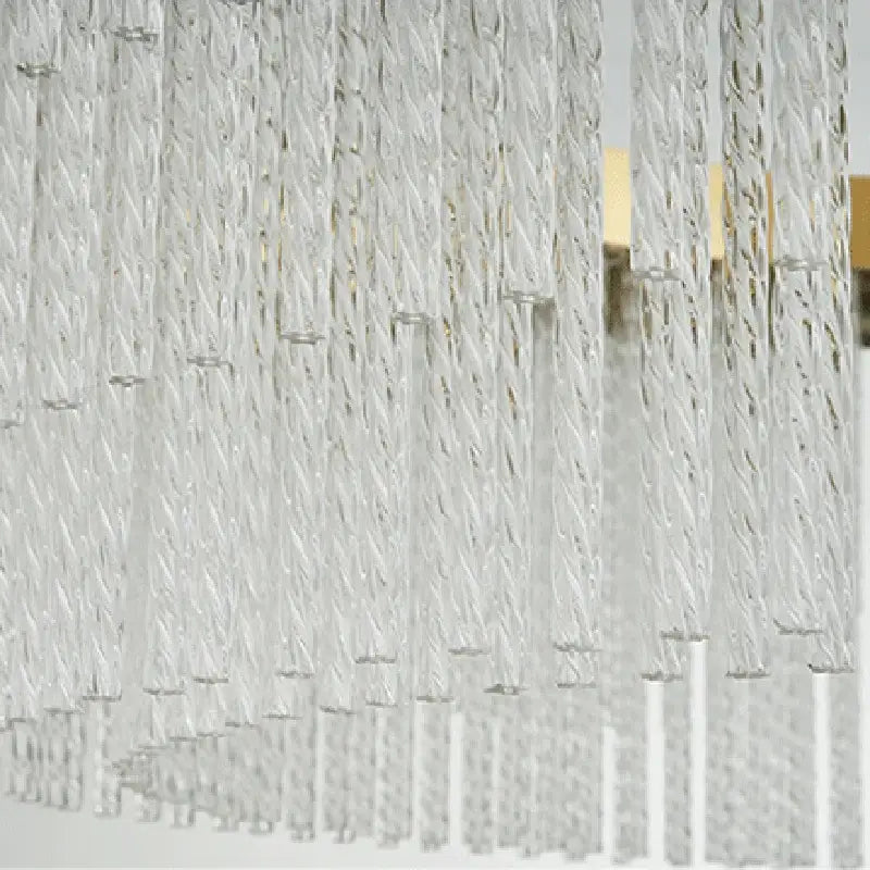 Clear twisted glass strands of the DecorBites™ elegant gold crystal chandelier with modern gold luster for home lighting
