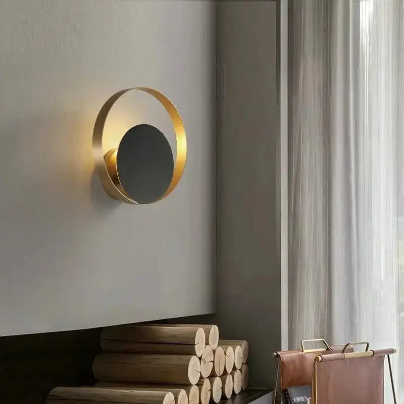 Gold-toned DecorBites™ Ellen modern wall sconce with minimalist design and reflective inner circle for sophisticated lighting