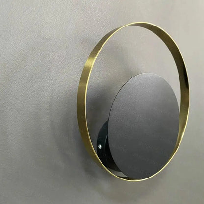 DecorBites™ ellen modern wall sconces feature a sleek circular brass frame with a matte black mirrored disc for lighting elegance