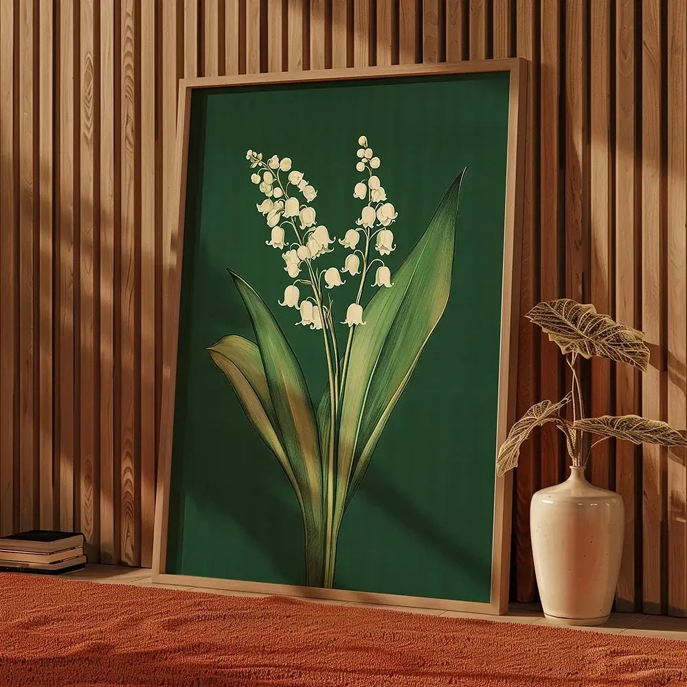 A framed DecorBites™ emerald green lily of the valley wall art with delicate white flowers and a light wood frame
