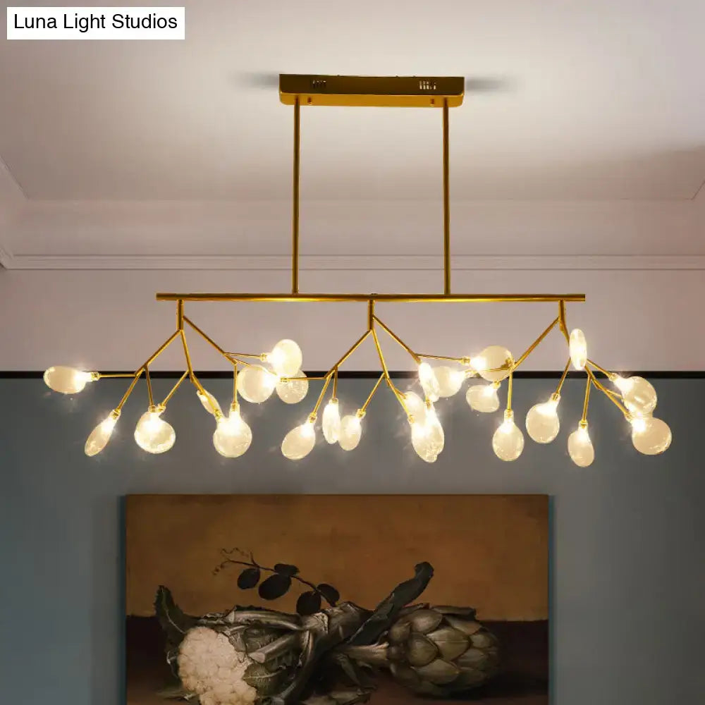 Gold-toned modern firefly led island pendant light with branching arms and frosted glass globe bulbs for dining room ceiling