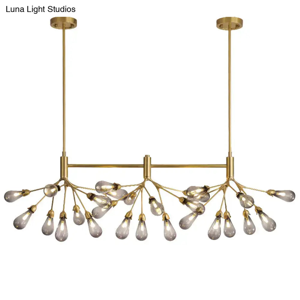 Brass-toned firefly suspension light with 27 teardrop-shaped glass bulbs on a central horizontal bar by decorbites