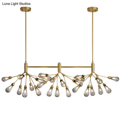 Brass-toned firefly suspension light with 27 teardrop-shaped glass bulbs on a central horizontal bar by decorbites