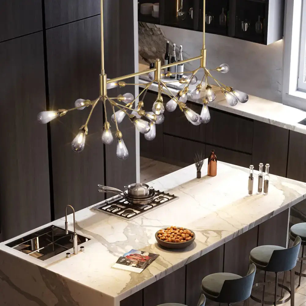 Gold-toned DecorBites firefly suspension light with brass finish featuring 27 frosted glass teardrop bulbs