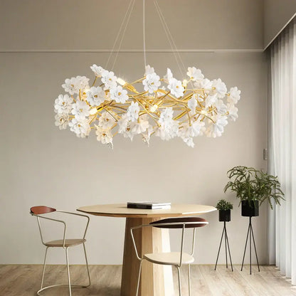 DecorBites™ floral french white ceramic chandelier with delicate white flowers and golden branches above dining table