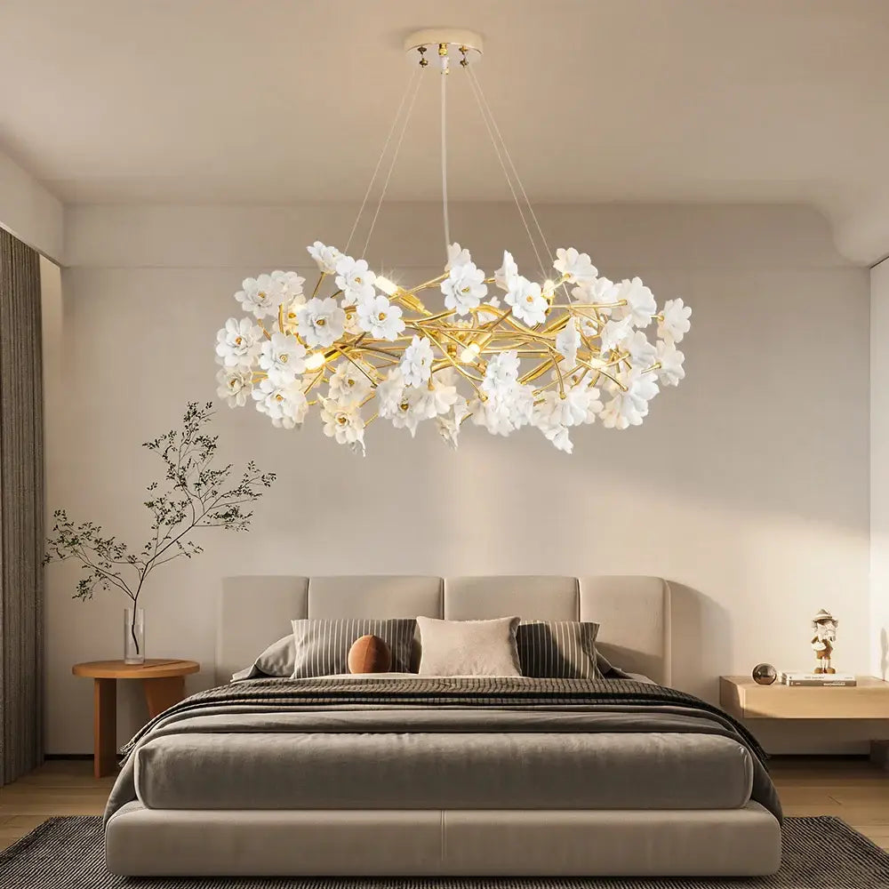 Elegant french white flower chandelier with gold-toned metal branches in white ceramic for romantic home décor